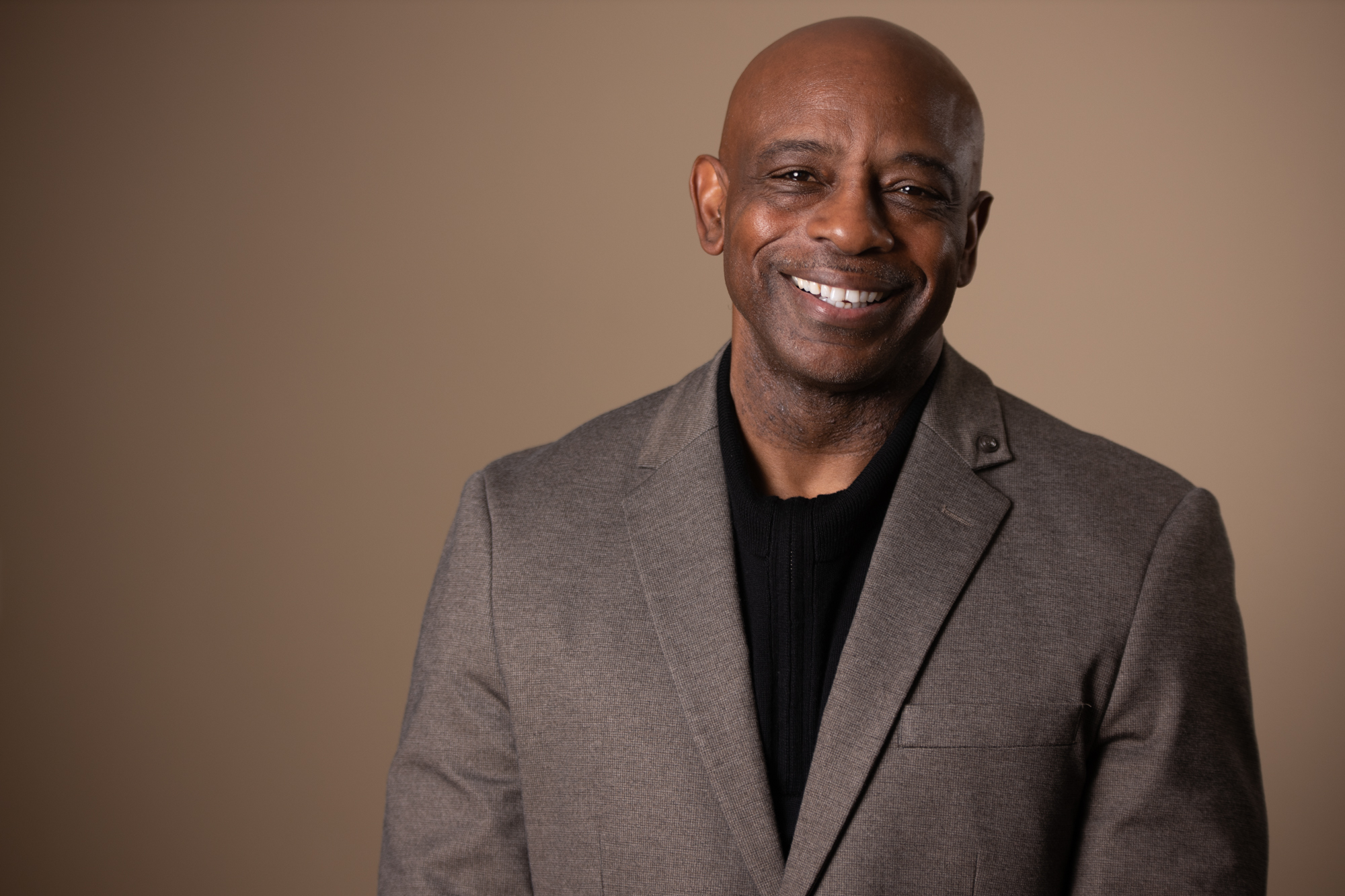 Warm studio portrait — blazer and smile