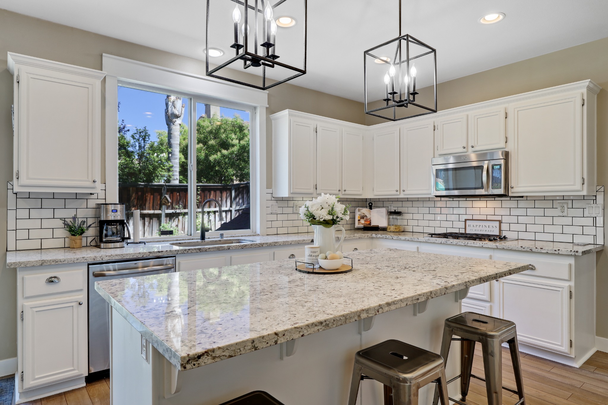 Kitchen with waterfall island and pendant lights
