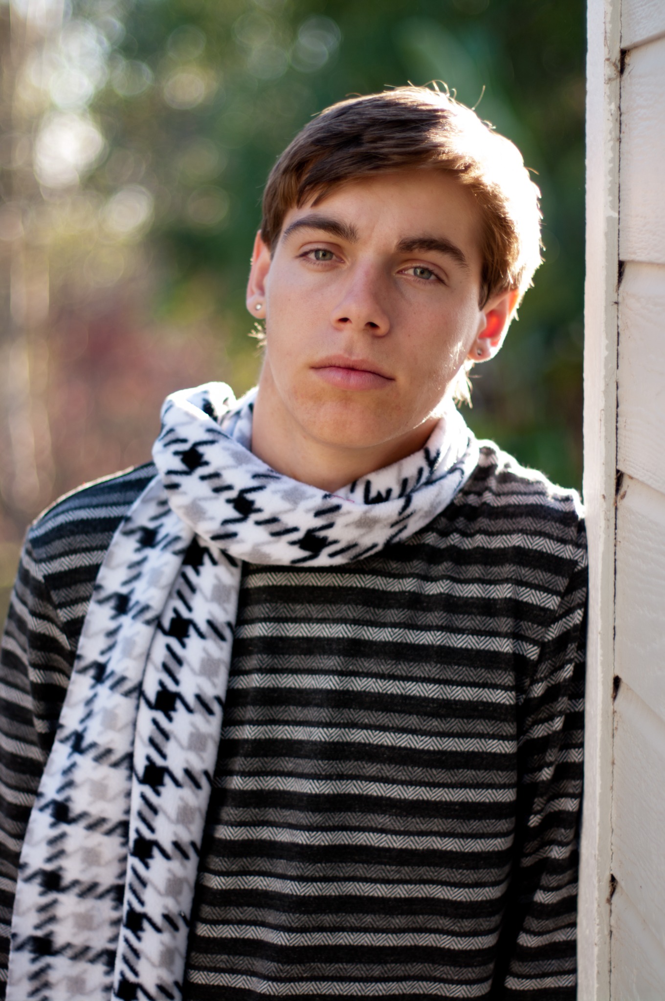 Casual portrait by siding — natural light